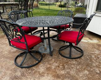 25) $425 - Cast iron round outdoor table and four chairs. Four red cushions included. 54" in diameter x 29".
