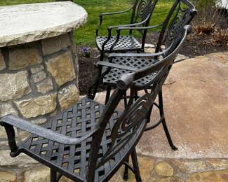 26) $275 - Set of three outdoor die cast iron bar stools. 24" x 24" x 30" x 48".