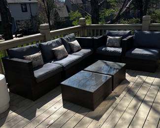 #100)  - $900 - Ten piece outdoor furniture set.  This Set includes all of the outdoor brown wicker sectional sofas pieces and the two matching coffee tables.  You will see these in the next several photos.  Grey Side chairs and white round side tables sold separately.  Set includes the brown cushions and accent pillows.  