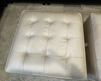 27) $500 - Set of two custom simulated leather stuffed ottomans with storage. 33" x 33" x 19".