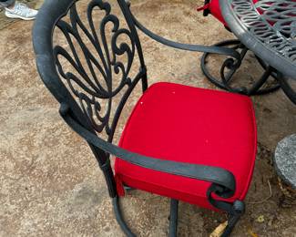 25) $425 - Cast iron round outdoor table and four chairs. Four red cushions included. 54" in diameter x 29".