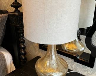11) $100 -Set of two glass lamps with white shades. Lamp base is 12" x 12" and shade measures 15". 32" in height. One lamp is missing a piece of the finial.