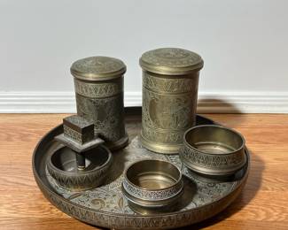 (6PC) CHASED ENGRAVED BRASS ITEMS | Including two cylindrical vessels to open low form vessels and ashtray with handle, and a footed round tray