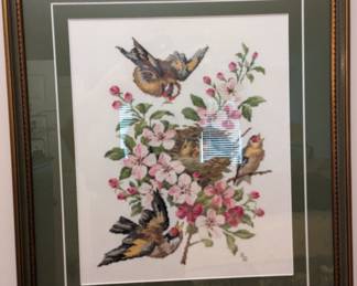 Needlepoint bird and flower artwork.