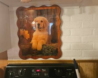 Laminated golden plaque on wood with mini clock.  Not above stove.
