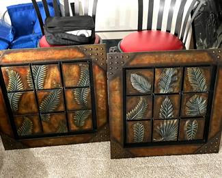 Pair of wall art pieces, red leather bar stools in background