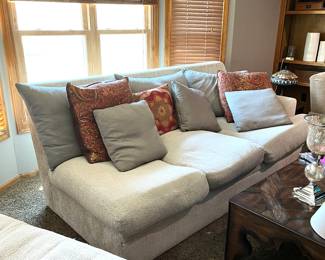 Nice comfortable three cushion sofa with one arm and chaise addition to side
