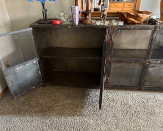 Opened doors to shelving below in beautiful metal cabinet