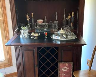 Portable bar with lower shelves, wine bottle holder, and wine glass hanger up top, very nice!