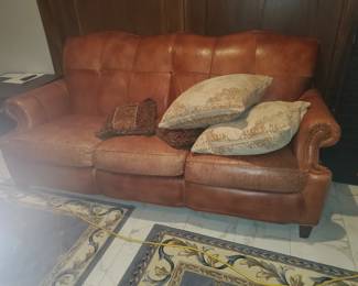 Weathered leather/faux sofa, nail-head trim, tufted back