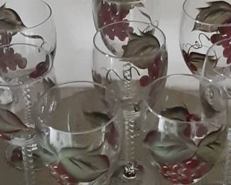 Unique and beautiful. Eight rarely used hand painted wine glasses. Beautiful grapes. The base/foot has a smaller design along with the artist's initial. 
