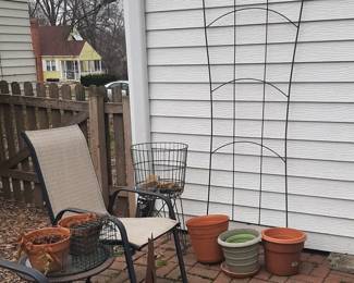 Tall garden trellis. Large, tall green wire plant stand. Pots and pots.