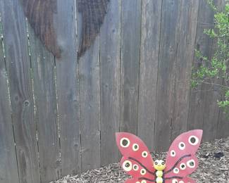 Yard art. Hanging angel wings and a colorful butterfly for the ground.