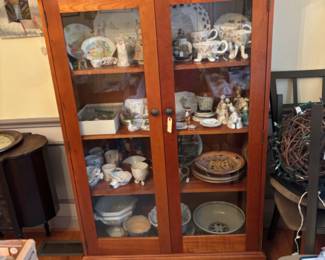 Cabinet full of beautiful pottery pieces