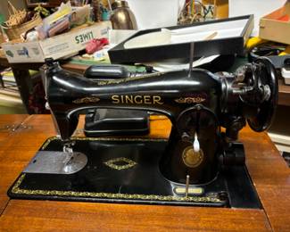 Vintage Singer sewing machine in cabinet with accessories