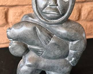 Inuit Soapstone carving "Man with Seal," 1981