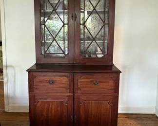19th Century Mahogany Stepback Cabinet with Silver Leaf Interior and Glass Front Doors. Measures 43" W x 21.5" D x 83" H. 