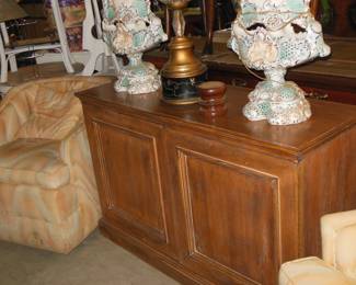 Pair swivel club chairs in flame stitch fabric. Small sideboard. Pair capodimonte lamps