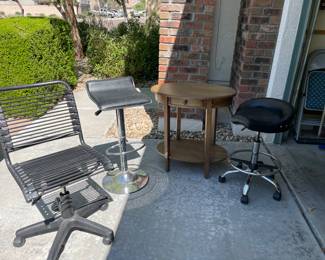 Bungee task chair, black adjustable bar stool, oval accent table, “saddle” stool