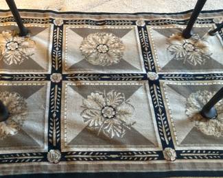 Small gold, black, and tan rug