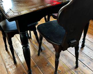 This is a Lovely and Unique table. The top is black marble type material. It has a beautiful pattern around the entire rim and in the center. The wooden table comes complete with 4 chairs! All in GREAT condition! 