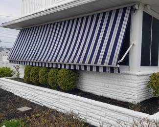 Electric awning then folds flat against the house to shield home from sun