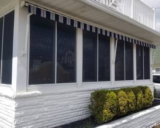 Electric awning shields home from sun