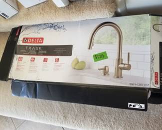 Delta TRASK pull down faucet - new in box. Polished chrome finish