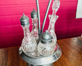 $40 ~ VTG 4 BOTTLE CRUET SET, SILVERPLATE. See chip on bottom of glassware as photographed. (To purchase or inquire about this item, please text 470.370.0348.)