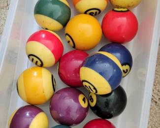 Vintage pool balls and cue sticks