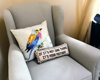 Upholstered chairs, wall art, many throw pillows