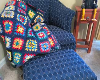 Upholstered chair, crocheted blanket