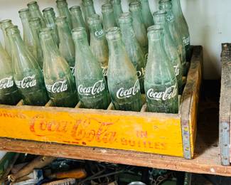 Lots of cola bottles and wooden crates