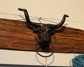 Local wood with metal bull. Handmade to use for a hanger 