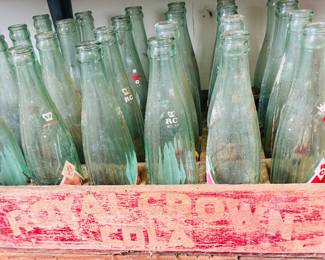 Lots of cola bottles and wooden crates