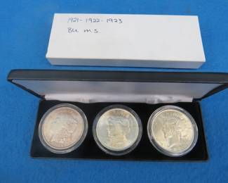 Lot 260. Three coin silver dollar set with coins as shown