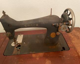 Antique Singer Sewing machine and cabinet. $150.00