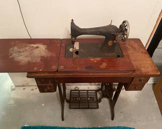 Antique Singer Sewing machine and cabinet. $150.00