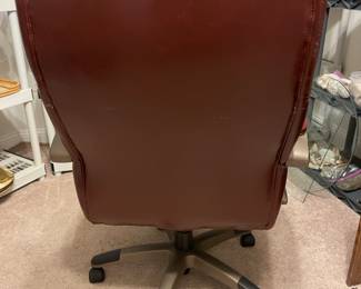 Leather office chair adjustable on casters. 