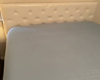 Queen Bed: Cream upholstered headboard, box and slats.  $350.00
