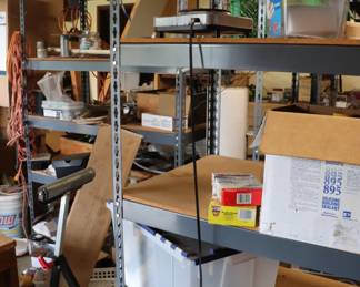 Metal storage shelves and a variety of tools, cords, and misc garage items