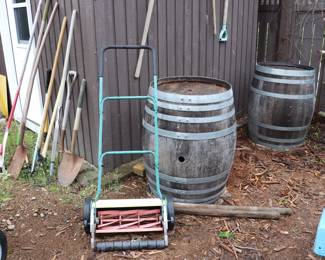 Push Blade Mower, assorted shovels and garden tools, and 2 Full Size Wine Barrels