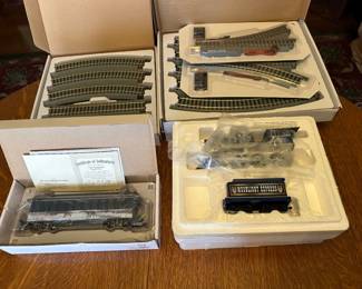 Several boxes of The Bradford Exchange train cars, track and power packs. New in box.