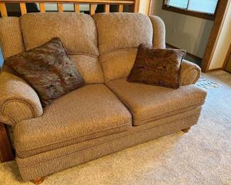 Neutral toned, two section loveseat with pillows 36 x 60 x 40 Located in the basement