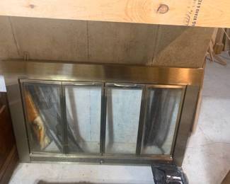 Glass fireplace front. Approximately 29.5 x 46. With extra parts. Located in the basement