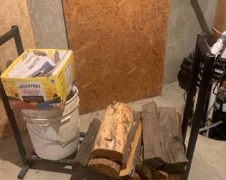 Firewood holder with firewood and newspapers. 31 x 37 x 15. Located in the basement