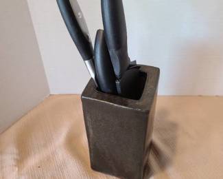 Sharper Image and Cuisinart kitchen knives in a clay holder