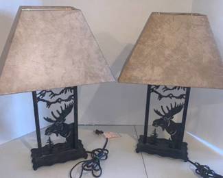 Table top lamp. Approximately 22 inches tall. They both have moose and tree cut outs