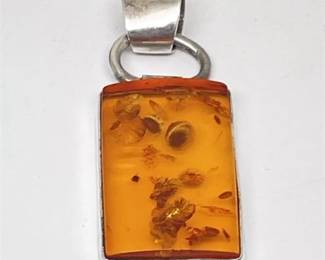 Lot 009   
Sterling Silver Seed Filled Amber Pendant