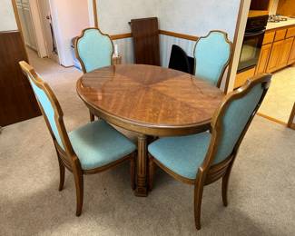 This is the dining table and four matching chairs.  There are at least one table leaves to extend the table.